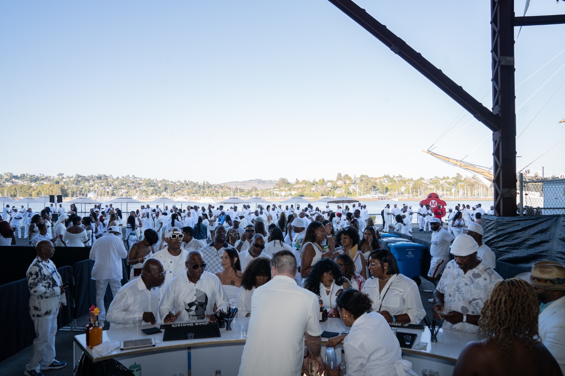 Attendees on the Mare Island waterfront with San Pablo Bay in the background